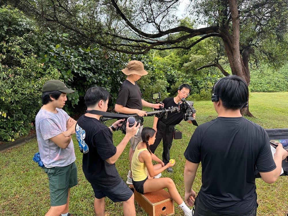 The Chowder Media crew filming on an outdoor shoot in Singapore